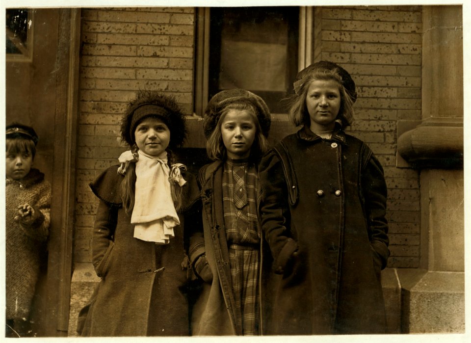 Newsgirls waiting for papers. Largest girl, Alice Goldman has been selling for 4 years. Newsdealer says she uses viler language than the newsboys do. Besie Goldman and Bessie Brownstein are LOC nclc.03238