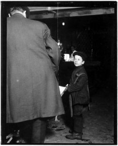 Newsie selling in a saloon in Washington Street at 10 pm. Tony Tomasula, 9 years old. Buffalo, N.Y. - NARA - 523274 photo