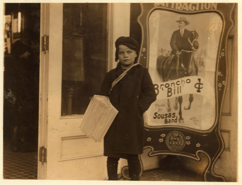 Newsie, ten years old. Going into a moving picture theatre with his papers. LOC nclc.03455