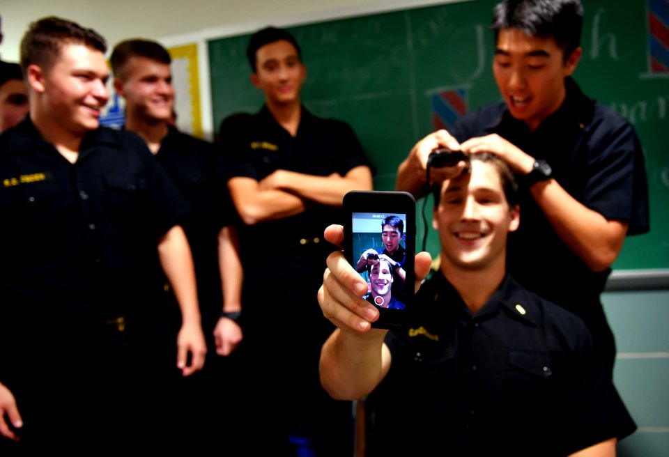 Midshipman videos himself as his head is shaved during a ceremony. (31051483576)