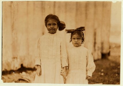 Mildred Kron, three years old, and Gertrude Kron, five years old. Help shuck oysters every day in the Barataria Canning Company. Live in New Orleans. See also photos 1973, 1976, 1977, 1997, LOC cph.3a01060 photo