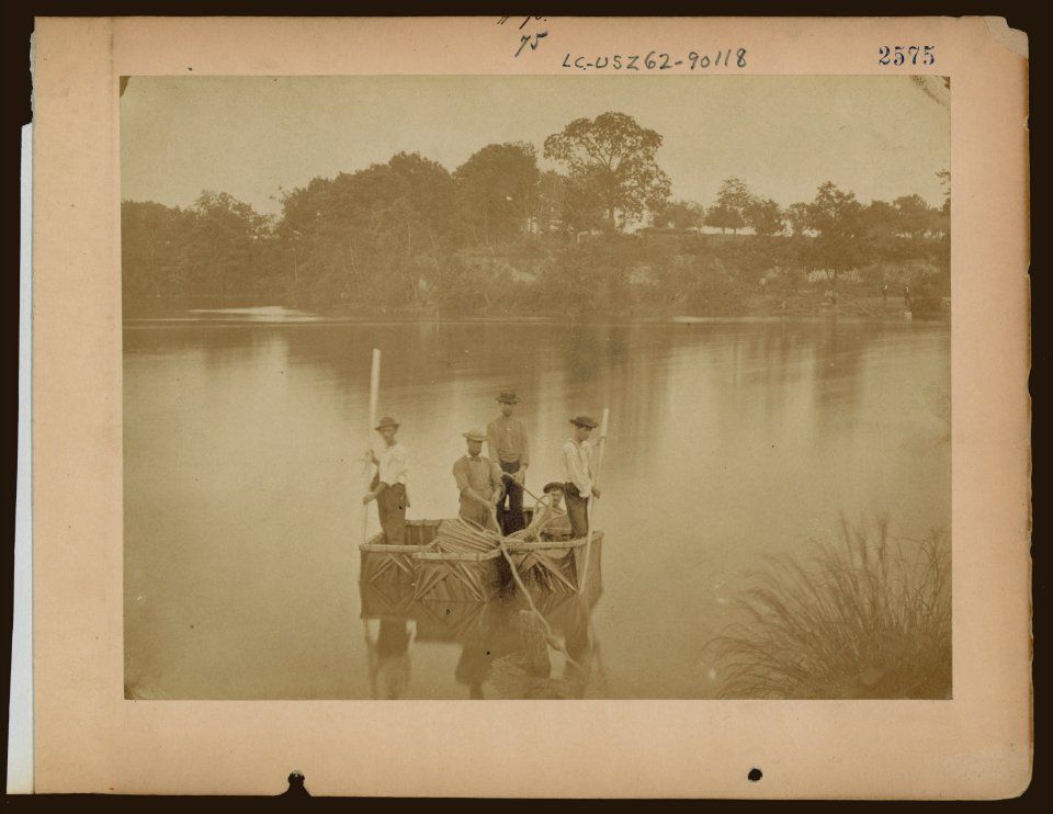 Military construction in northern Virginia- five men in three blanket boats strapped together on the Potomac River LCCN97502068