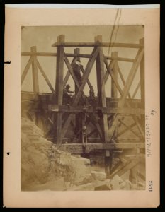 Military railroad operations in northern Virginia- two men boring holes in bridge trestles and man with Haupt's Torpedo LCCN97502065