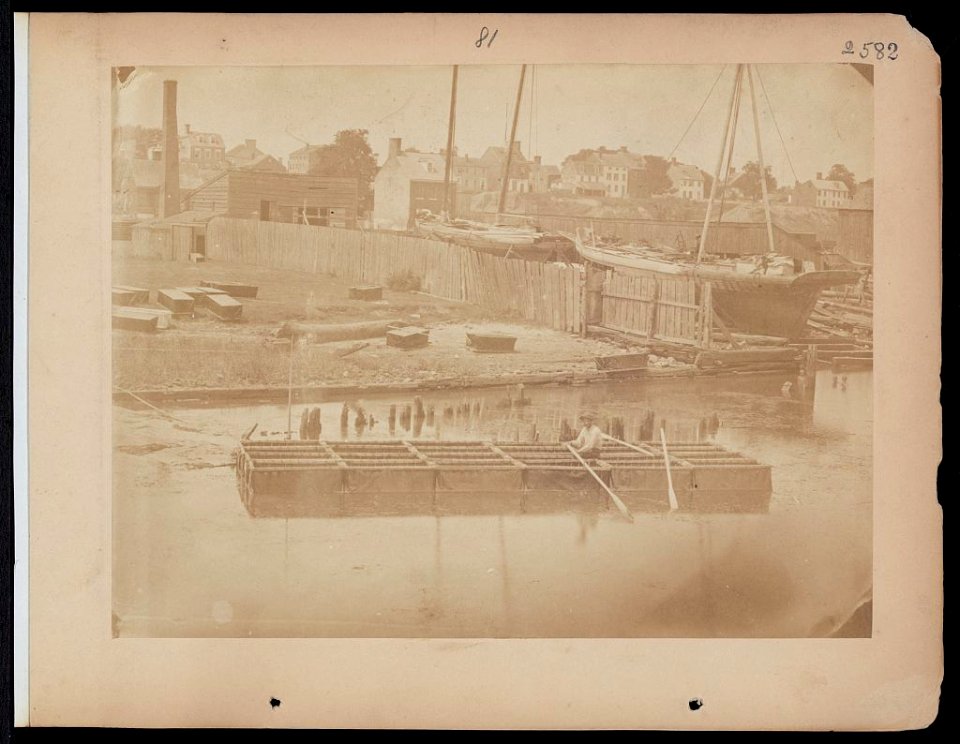 Military construction in northern Virginia- man rowing raft of blanket boats on the Potomac River LCCN2006676198