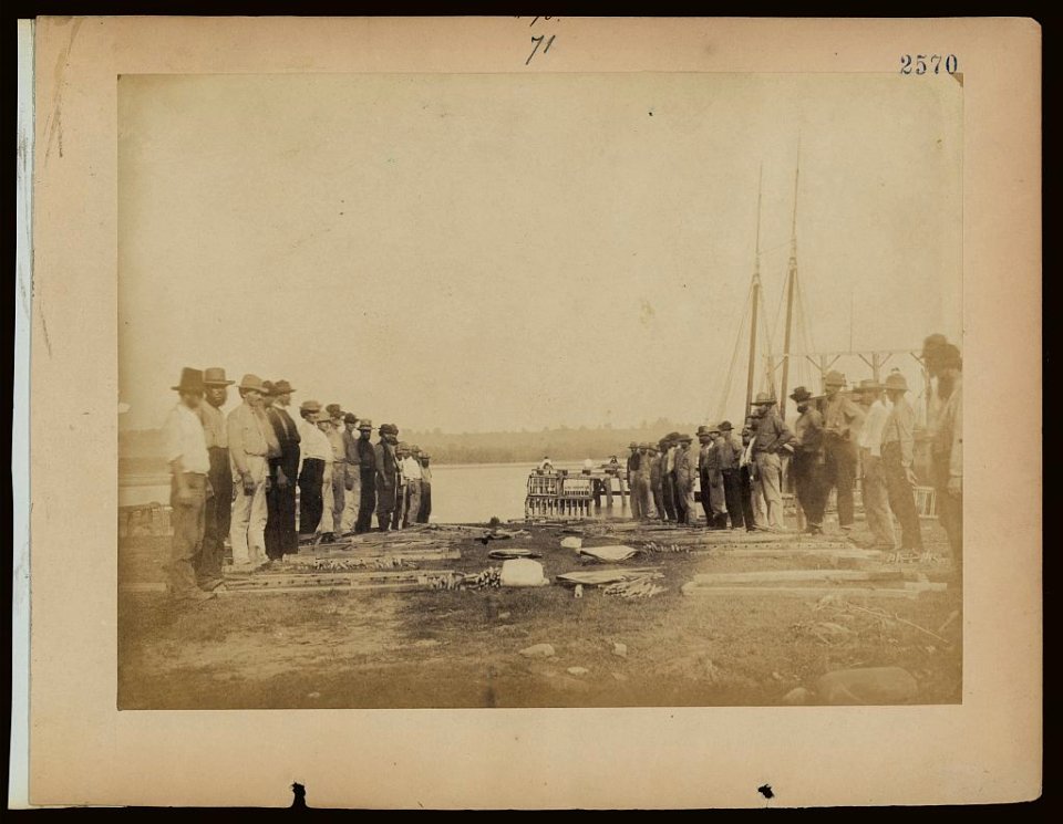 Military construction in northern Virginia- men standing on Potomac River bank with blanket boat frames not yet assembled LCCN2006676188