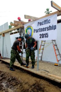Military engineers from the US and Japan help build a children's classroom at Wailevu, Fiji 150613-N-HE318-004