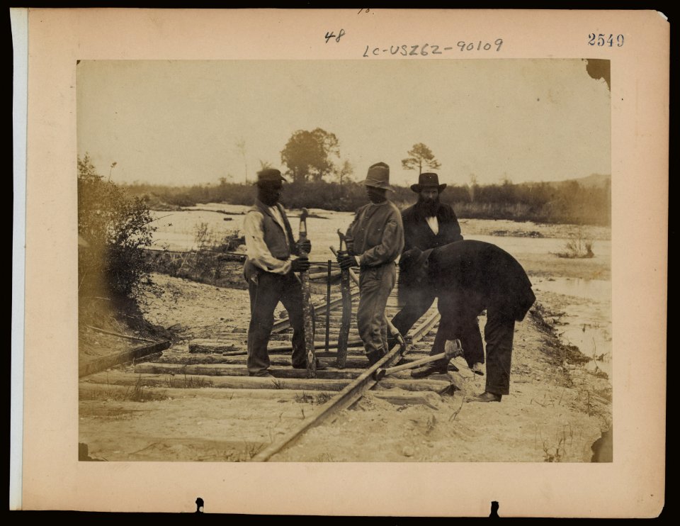 Military railroad operations in northern Virginia- men using levers for loosening rails LCCN97503194