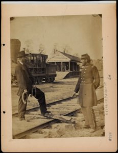 Military railroad operations in northern Virginia- soldier and another man standing at railroad tracks in front of locomotive LCCN97502023