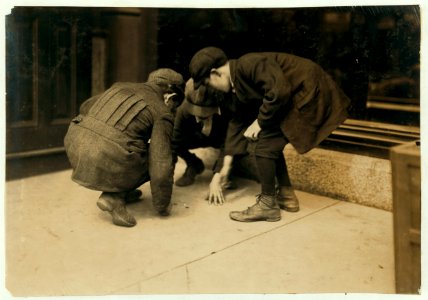 Mill boys pitching pennies on the Main St. in the afternoon. One said he sweeps. One said 'I was workin' but got canned 'cause I was not fast enough.' The other was 'jest hangin' around.' LOC nclc.03008