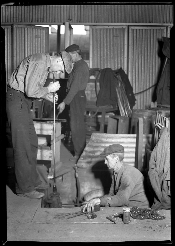 Millville, New Jersey - Glass bottles. (One man sitting while other man blows glass.) - NARA - 518667