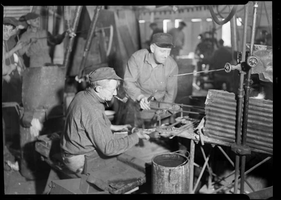 Millville, New Jersey - Glass bottles. T. C. Wheaton Co. A gaffer finishing a wide mouthed bottle. The man on the... - NARA - 518637