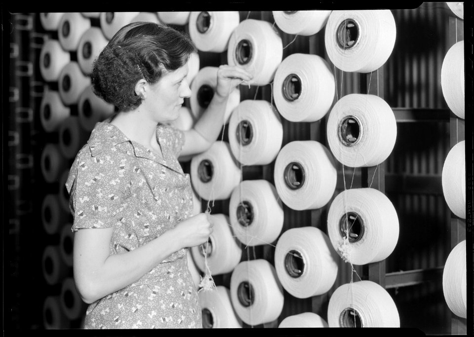 Millville, New Jersey - Textiles. Millville Manufacturing Co. (Woman standing at large spools of thread.) - NARA - 518675