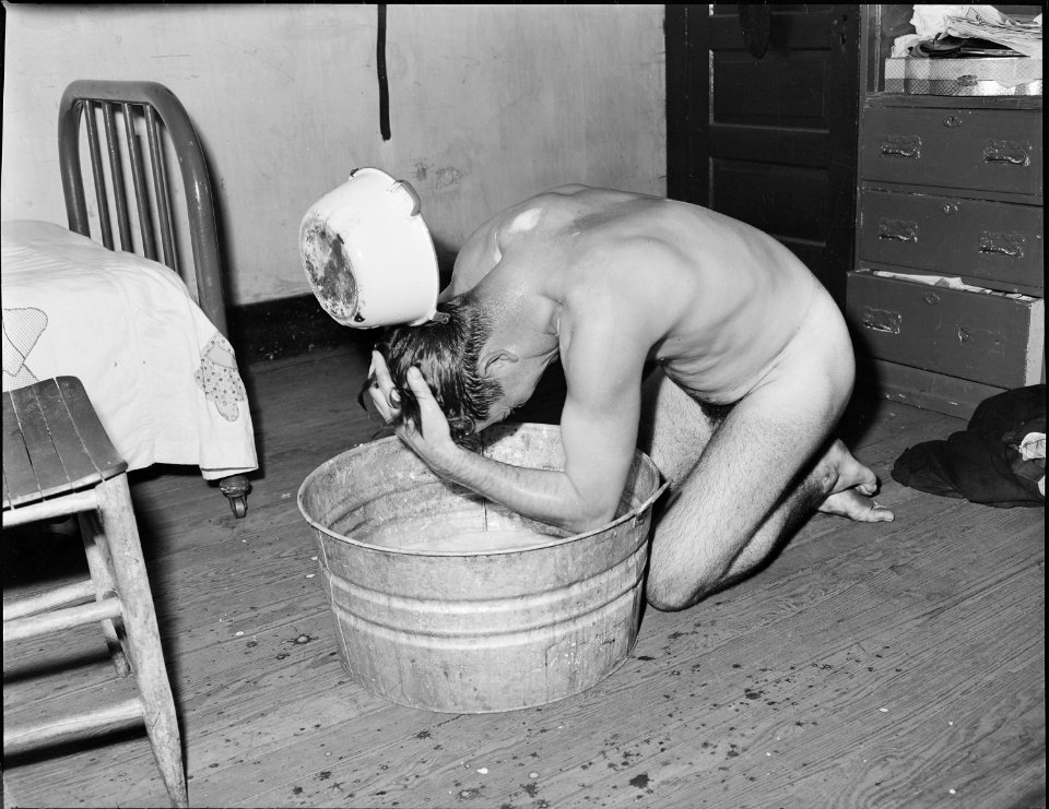 Milong Bond, tipple worker, taking a bath. There is no washhouse for mine nor tipple workers. Mullens Smokeless Coal... - NARA - 540958