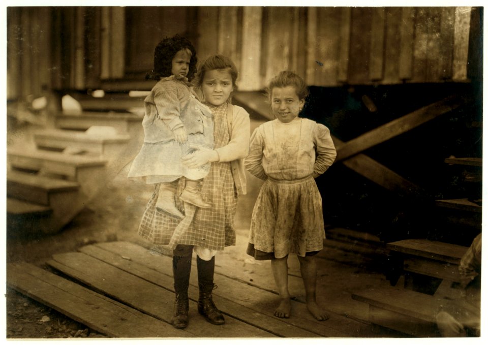 Millie (about seven yrs. old) and Mary John (with the baby) eight years old. Both shuck oysters at the Alabama Canning Co. This is Mary's second year. She said, 'I shucks six pots if I don't LOC nclc.00846