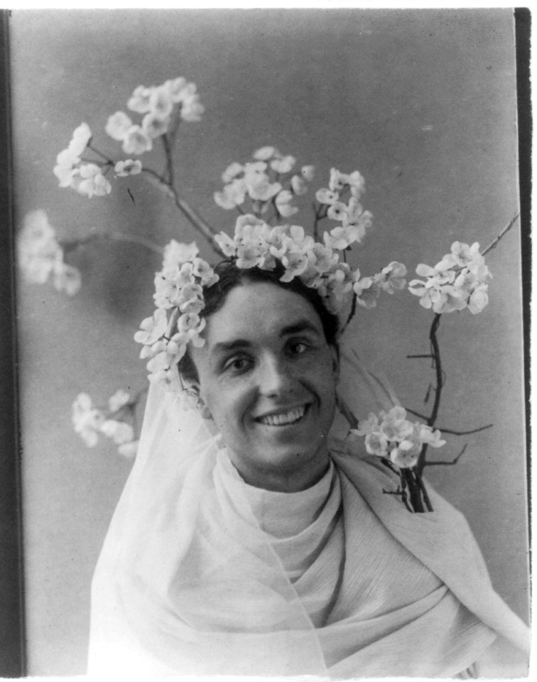 Mills Thompson, head-and-shoulders portrait, facing right, with cherry blossoms in hair LCCN2001703940