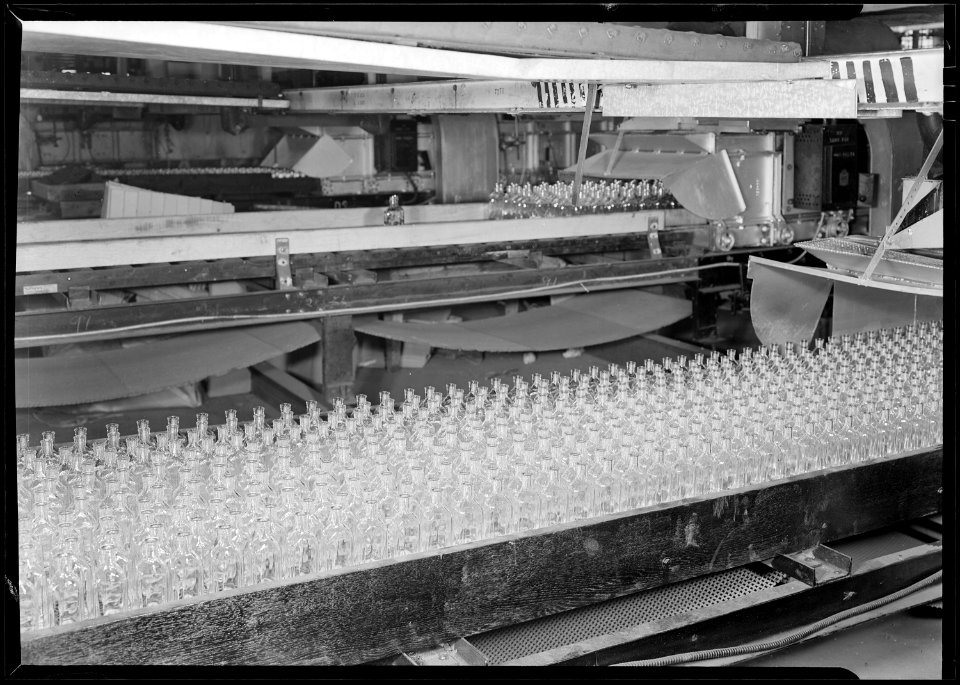 Millville, New Jersey - Glass bottles. (Numerous bottles in foreground and bottles on a conveyor belt.) - NARA - 518673
