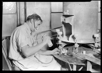 Millville, New Jersey - Glass bottles. Paint sprayer, T. C. Wheaton Co. art room. This man is spraying white glass... - NARA - 518632