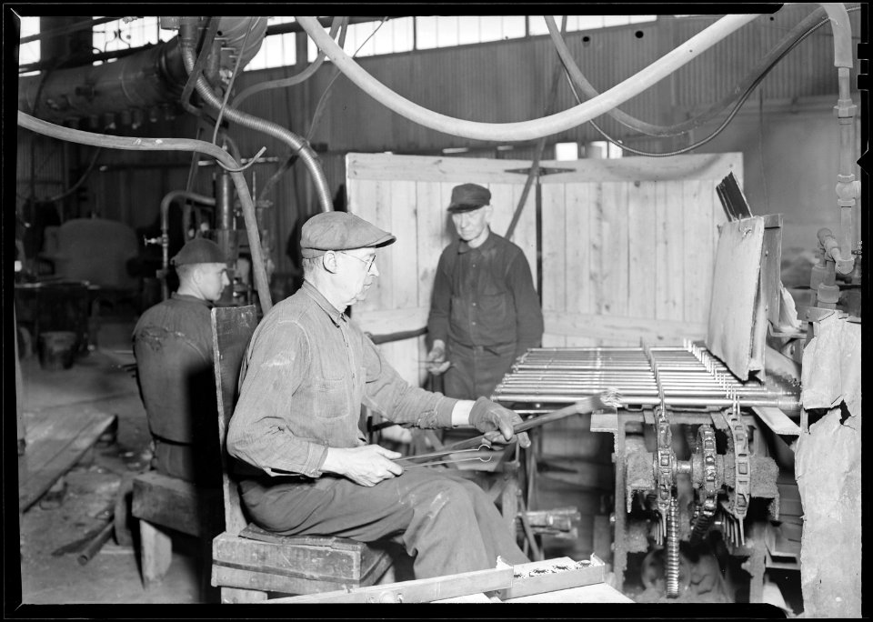 Millville, New Jersey - Glass bottles. T.C. Wheaton Co. A pressing shop finishing door knobs. Pressed door knobs are... - NARA - 518638