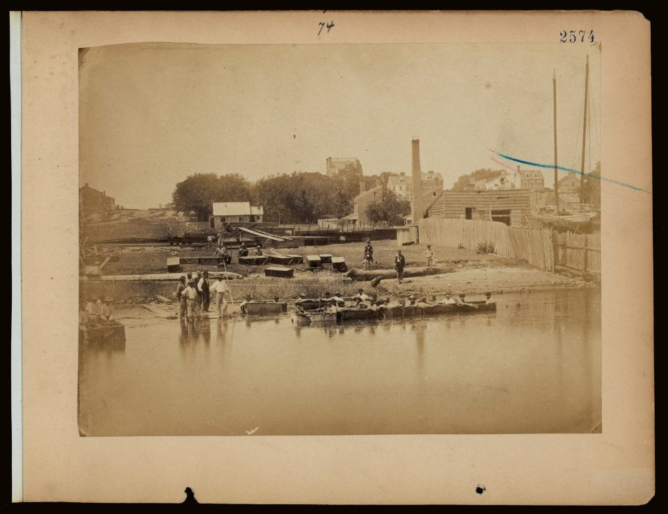Military construction in northern Virginia- men sitting in blanket boats strapped together on the Potomac River LCCN2006676191