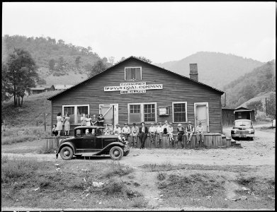 Miners and their families gather around the community store and office. P V & K Coal Company, Clover Gap Mine... - NARA - 541327 photo