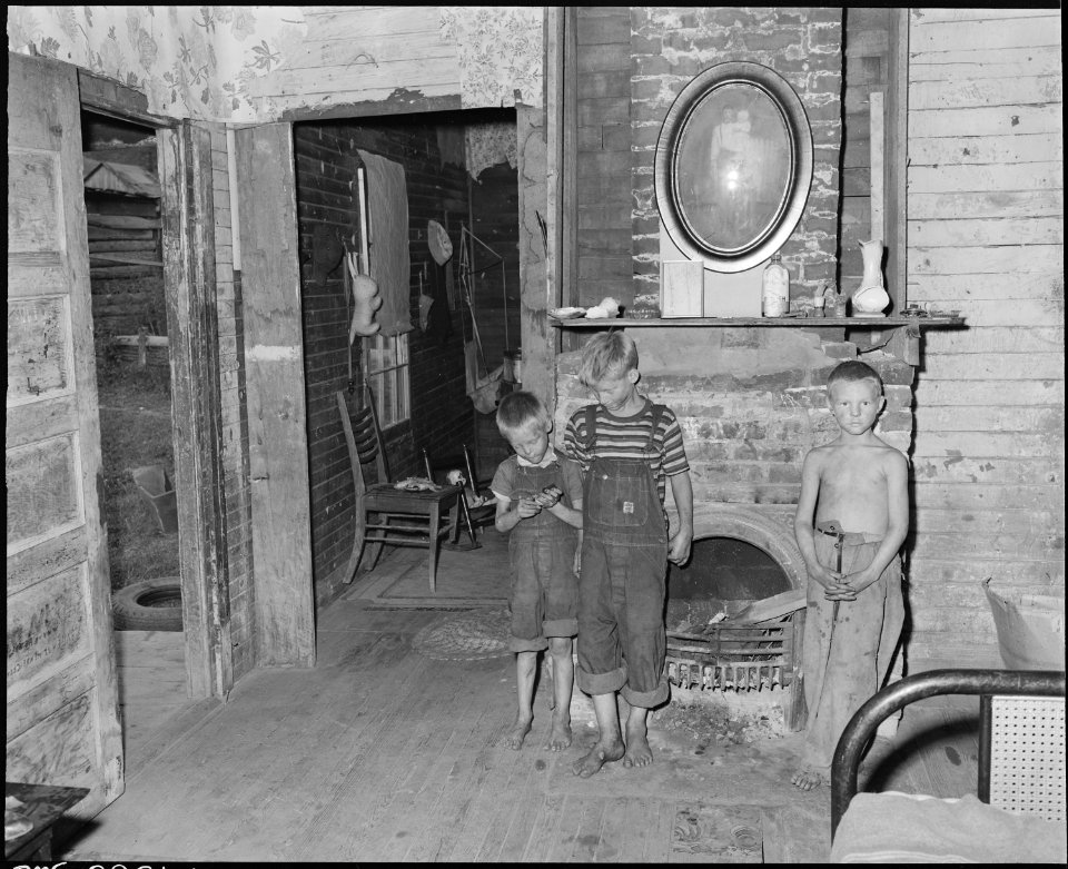Miners children in front of the fireplace in Monroe Jones' four room house. This grate fire and the kitchen fire... - NARA - 541188