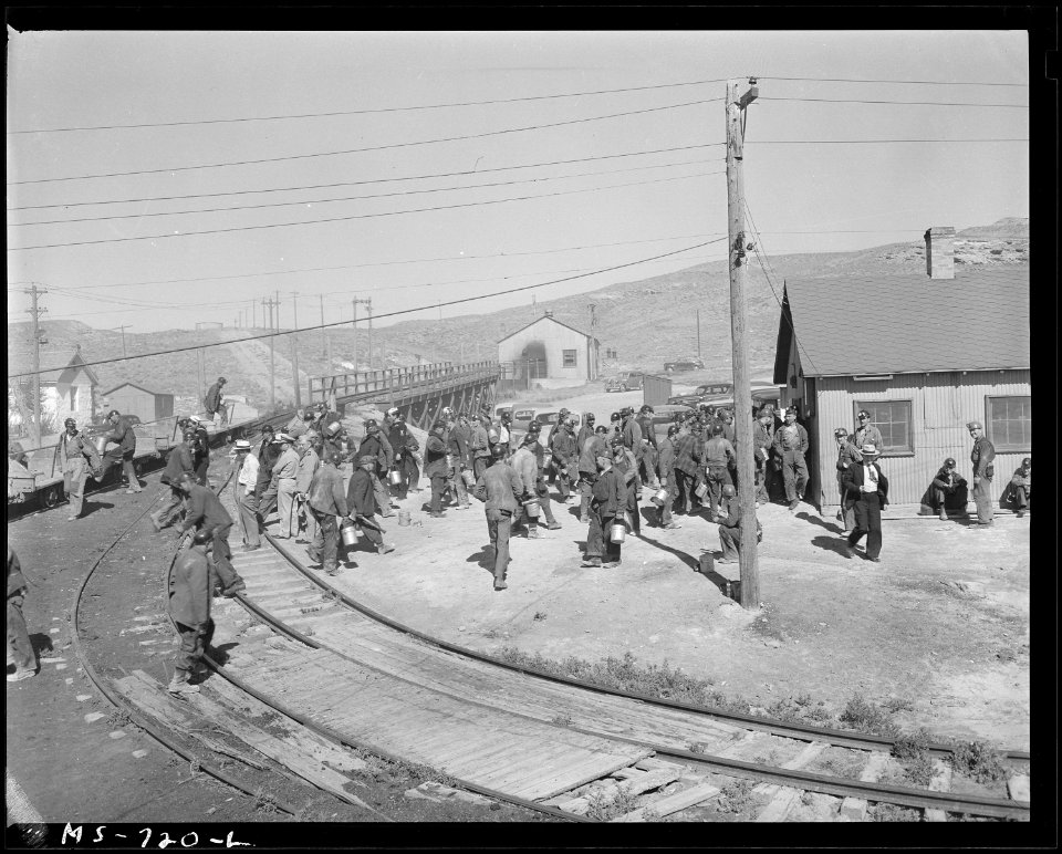 Miners from the morning shift walk to the mine office from shuttle cars at end of their shift. Union Pacific Coal... - NARA - 540568