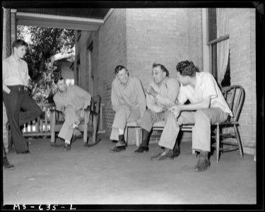 Miners who live in hotel, talking together on front porch. Utah Fuel Company, Castle Gate Mine, Castle Gate, Carbon... - NARA - 540541