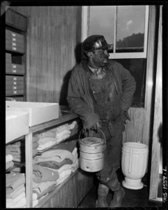 Miner who is shopping with his family in the subsidiary company store. This store carries a large selection of good... - NARA - 540855