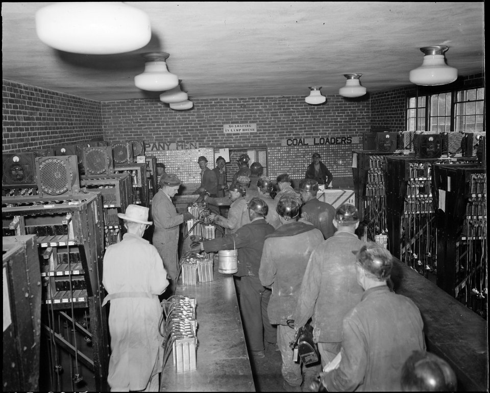 Miners checking in their safety lamps in the lamp house. The Pocahontas Corporation, Mines 33-34, Bishop, Tazewell... - NARA - 541081