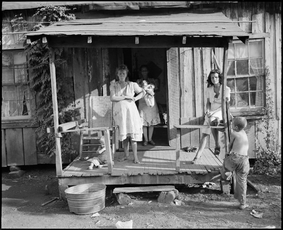 Miners' wives and children on the front porch of a typical, fifty year old house. Kentucky Straight Creek Coal... - NARA - 541201