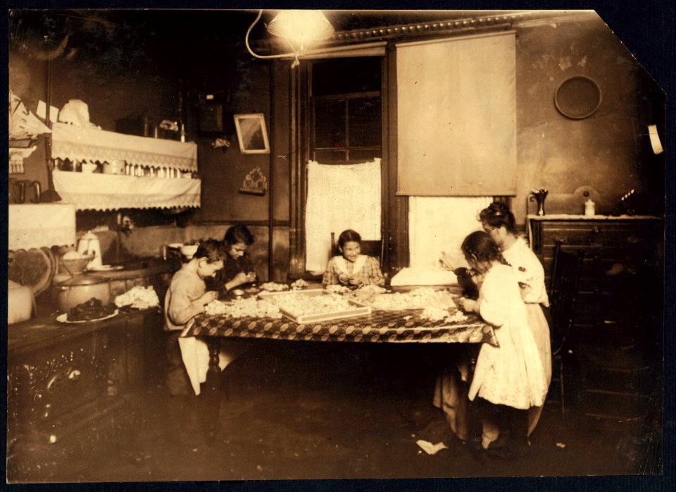 Night scene. 7-30 P.M. January 29, 1912. Making violets, and they often work later. Pollinni family, 5 Carmine St., N.Y. living in a reary (i.e., rear.) tenement. The six year old helps LOC nclc.04137