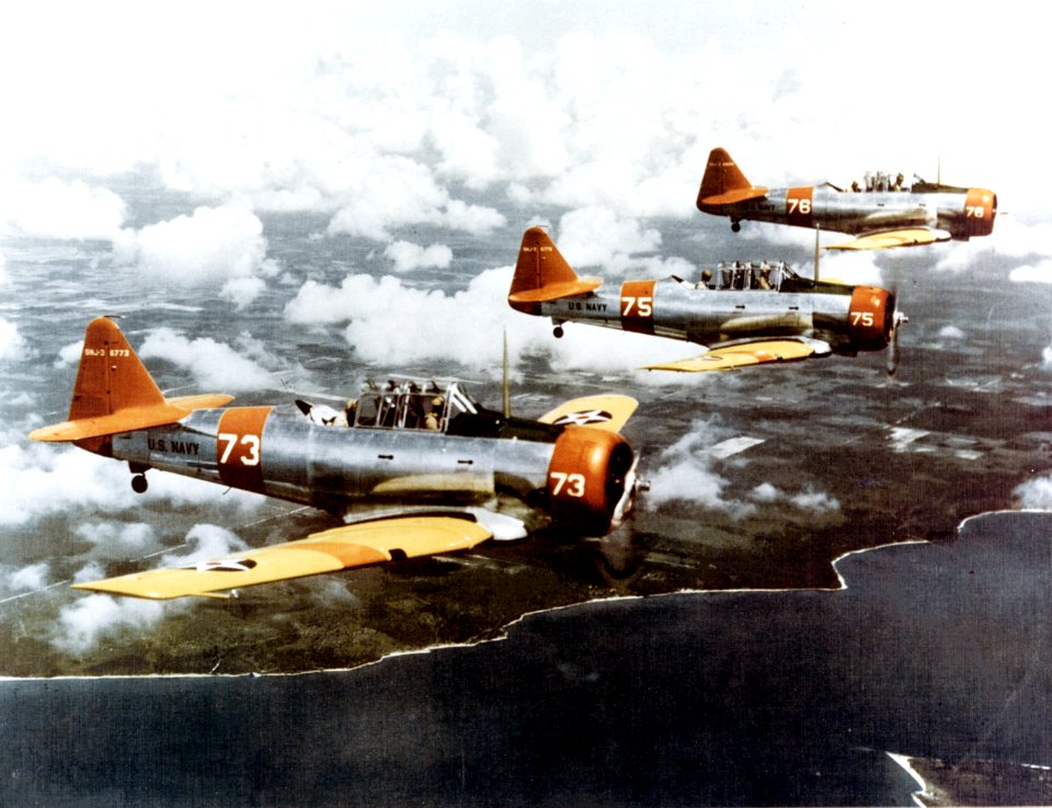 North American SNJ-3 Texans fly in formation, circa in 1941 (NH 82610-KN)