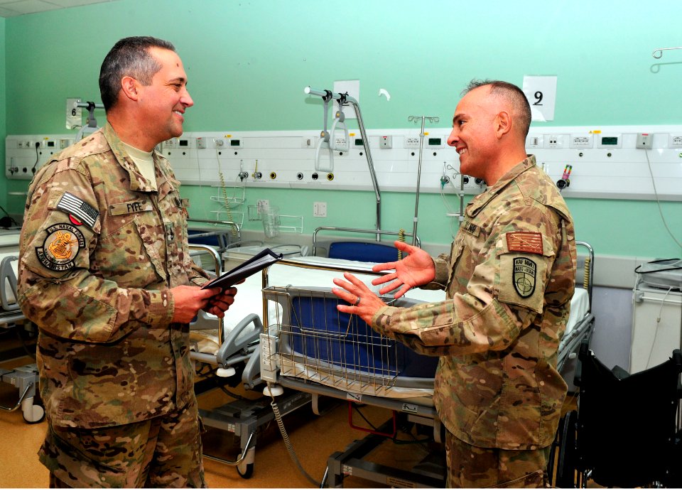 NOSC Phoenix and Anchorage Sailors discuss patient care at Role 3 Multinational Medical Unit, Kandahar Airfield, July 3, 2015 150703-N-SQ656-283