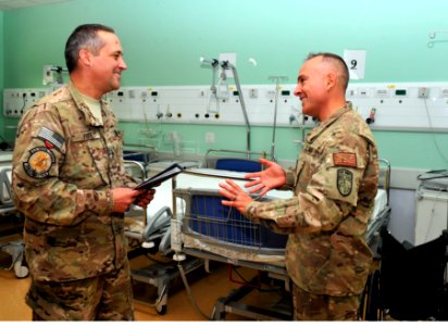 NOSC Phoenix and Anchorage Sailors discuss patient care at Role 3 Multinational Medical Unit, Kandahar Airfield, July 3, 2015 150703-N-SQ656-283