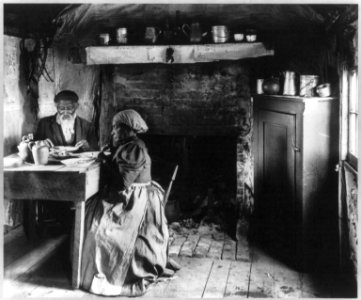 Old African American couple eating at the table by fireplace, rural Virginia LCCN2001703811