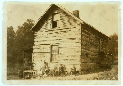 Old Log cabin, the home of Wm. Mullens and family, - near Charleston, W. Va. He carries on work in Charleston (Brown Milling Produce Co.) as well as this farm. LOC nclc.04419