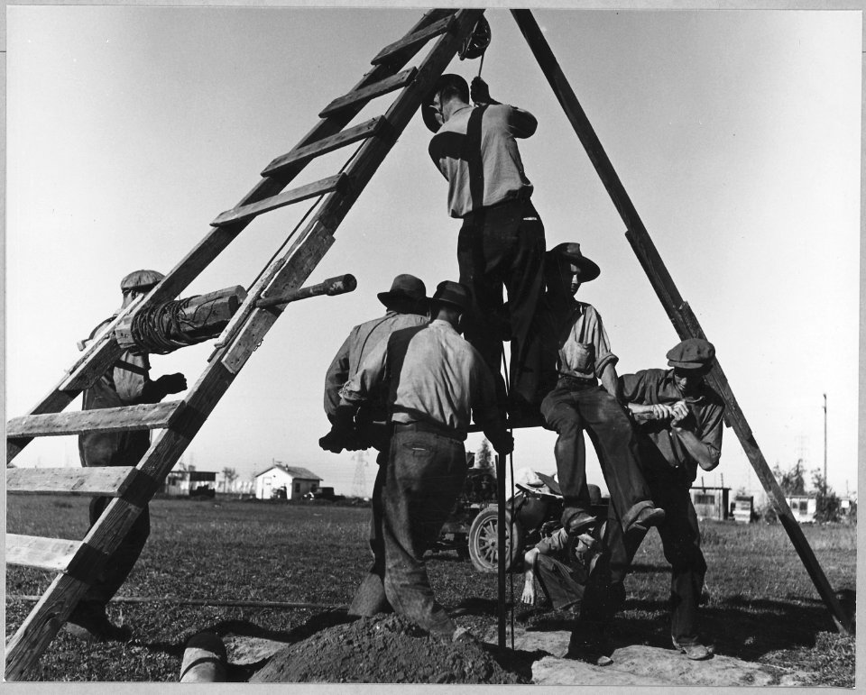 Olivehurst, Yuba County, California. Neighbors join in to help dig a well for family who still live . . . - NARA - 521593