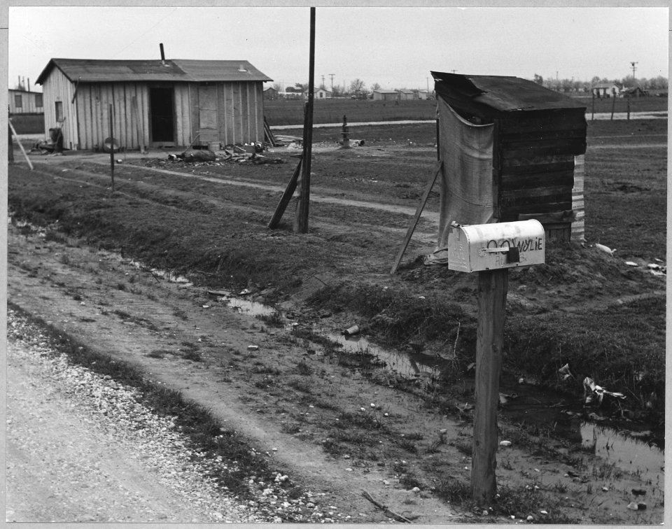 Olivehurst, Yuba County, California. Self-built house and privy. Note scarcity of windows and lack o . . . - NARA - 521601