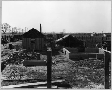 Olivehurst, Yuba County, California.... Note building material, railroad ties, second-hand lumber, a . . . - NARA - 521589 photo