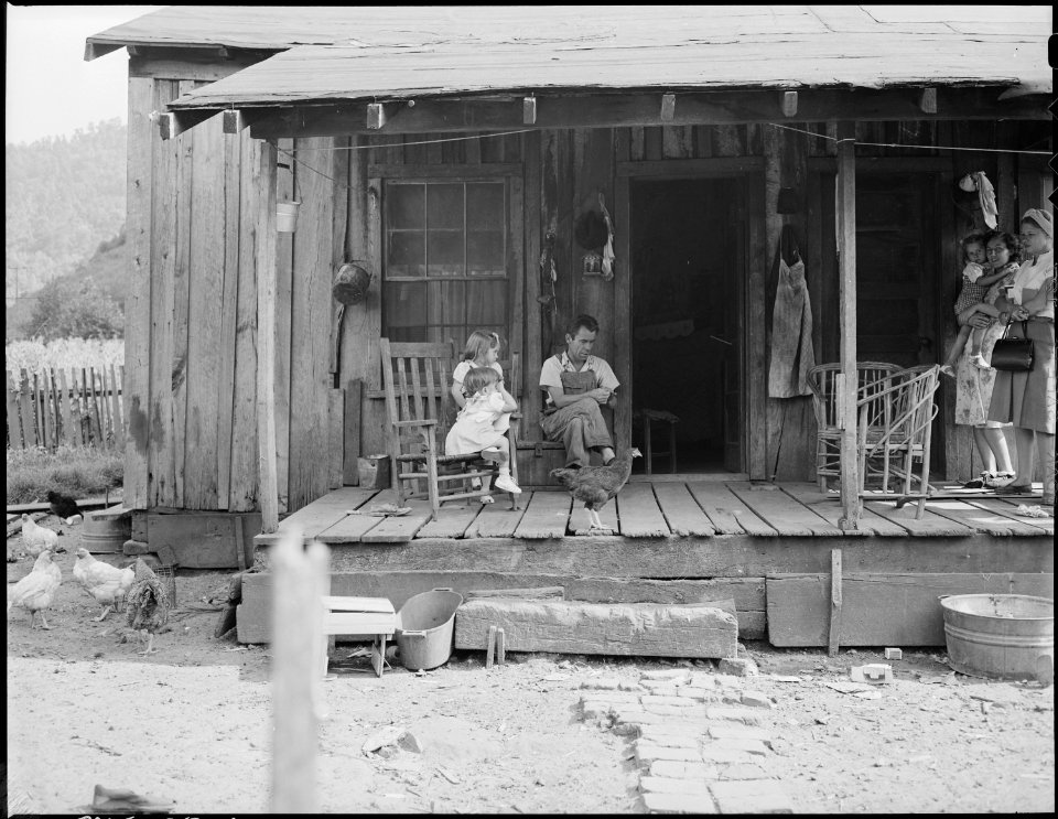 Oliver Hinkle, disabled mine, and children on the front porch of his house for which he pays $9 monthly. Kentucky... - NARA - 541231