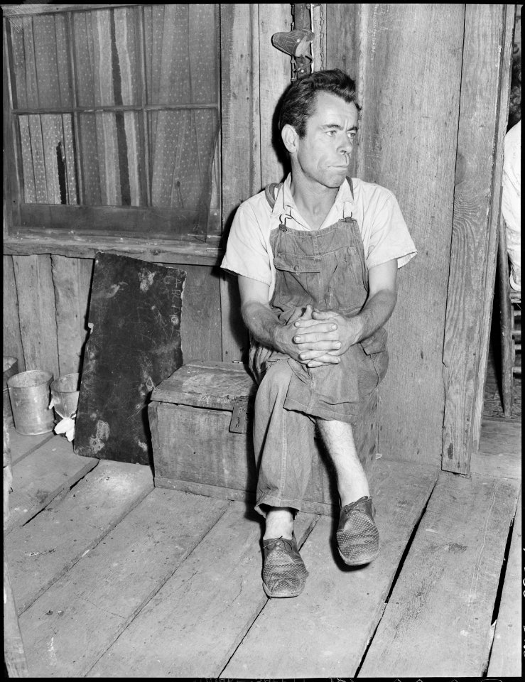 Oliver Hinkle, a miner, disabled for fifteen months with a crushed ankle, in the front porch of his house. Kentucky... - NARA - 541228