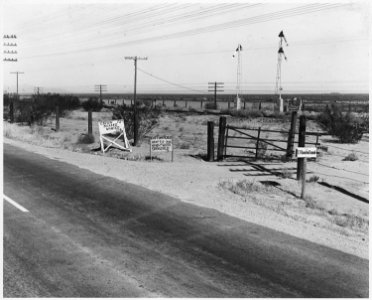 On Highway 84, Pinal County, Arizona. Ranch advertisement during cotton harvest. Highway signs readi . . . - NARA - 522493