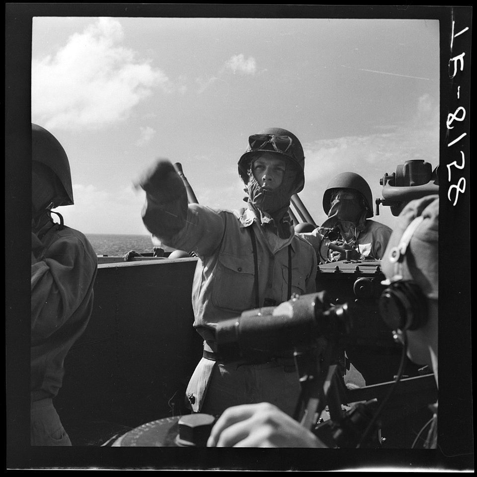 On board USS Lexington (CV-16) off Kwajalein. Marine gun captain points out JAP Kate moving in to launch torpedo. - NARA - 520797