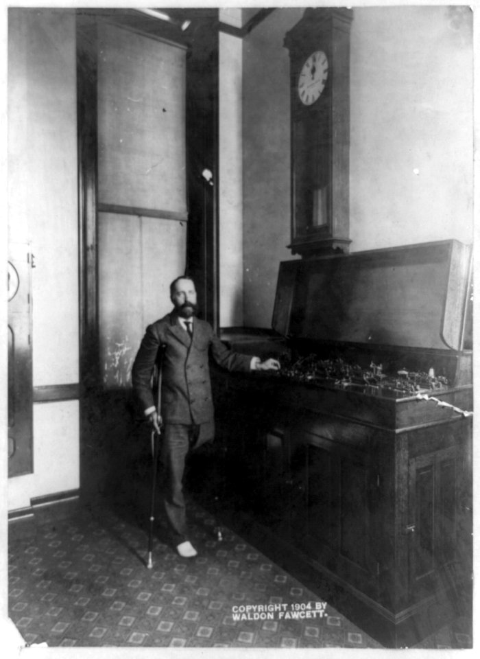 One-legged man on crutches and instrument, with clock above reading 12-00, at the United States Naval Observatory, 3450 Massachusetts Ave., N.W., Washington, D.C.) - copyrighted and LCCN89714234