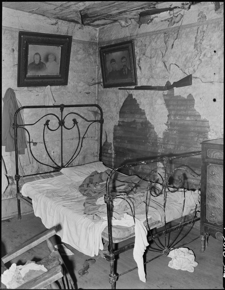 One of the three rooms renting for $4 monthly in which eight people, four adults and four children live. This house... - NARA - 541171