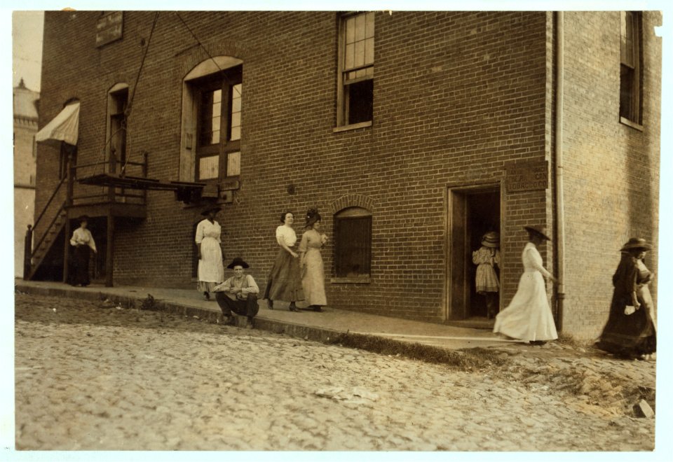 One of the very little girls (going through door) that roll cigarettes in the Danville (Va.) Cigarette Factory. See other photos at noon. Taken at 6-45 A.M. LOC nclc.04741