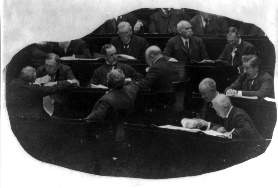 Opening of the 60th Congress - view of group of Congressmen at their desks, reading and consulting each other LCCN2004678652