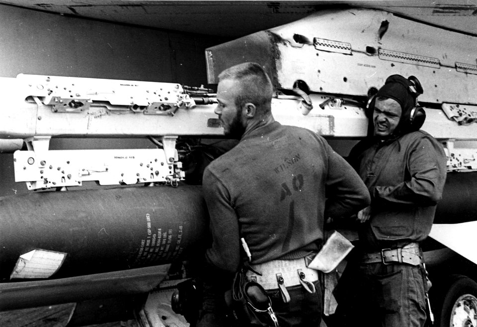 Ordnance men apply Mk 82 to VF-194 F-8E c1967