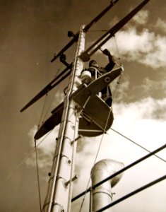 Painting the mast of a submarine chaser, Marine Construction Company, 1942 (27863335776)