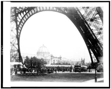 Palace of Fine Arts seen through the base of the Eiffel Tower, with people walking along parterre in background, Paris Exposition, 1889 LCCN92519772
